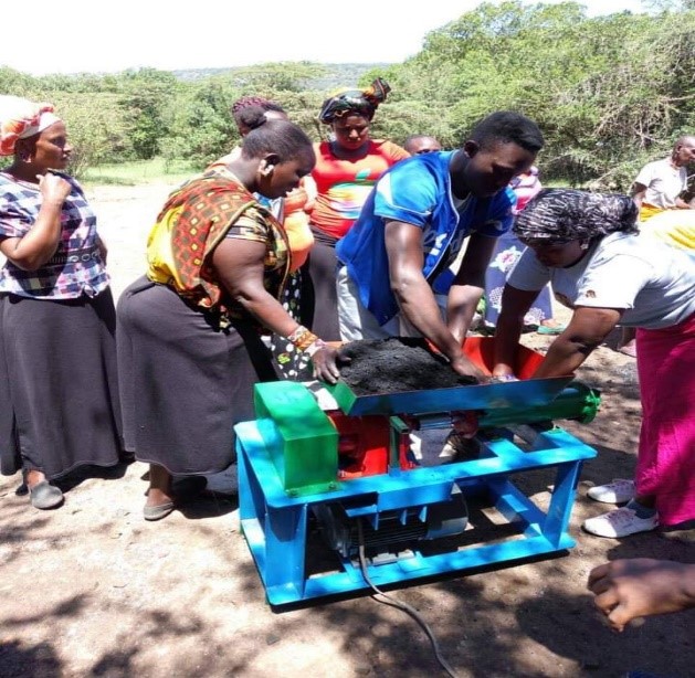 Kilifi County women and youth using briquette making machines
