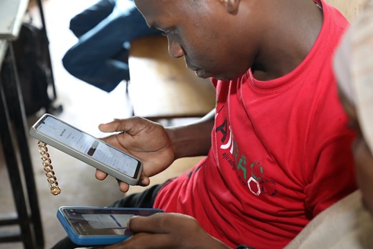 Abubakar Abdulaziz Diko showcasing the digital skills he gained through the Ajira Digital Literacy Program at the Hindi Digital Center