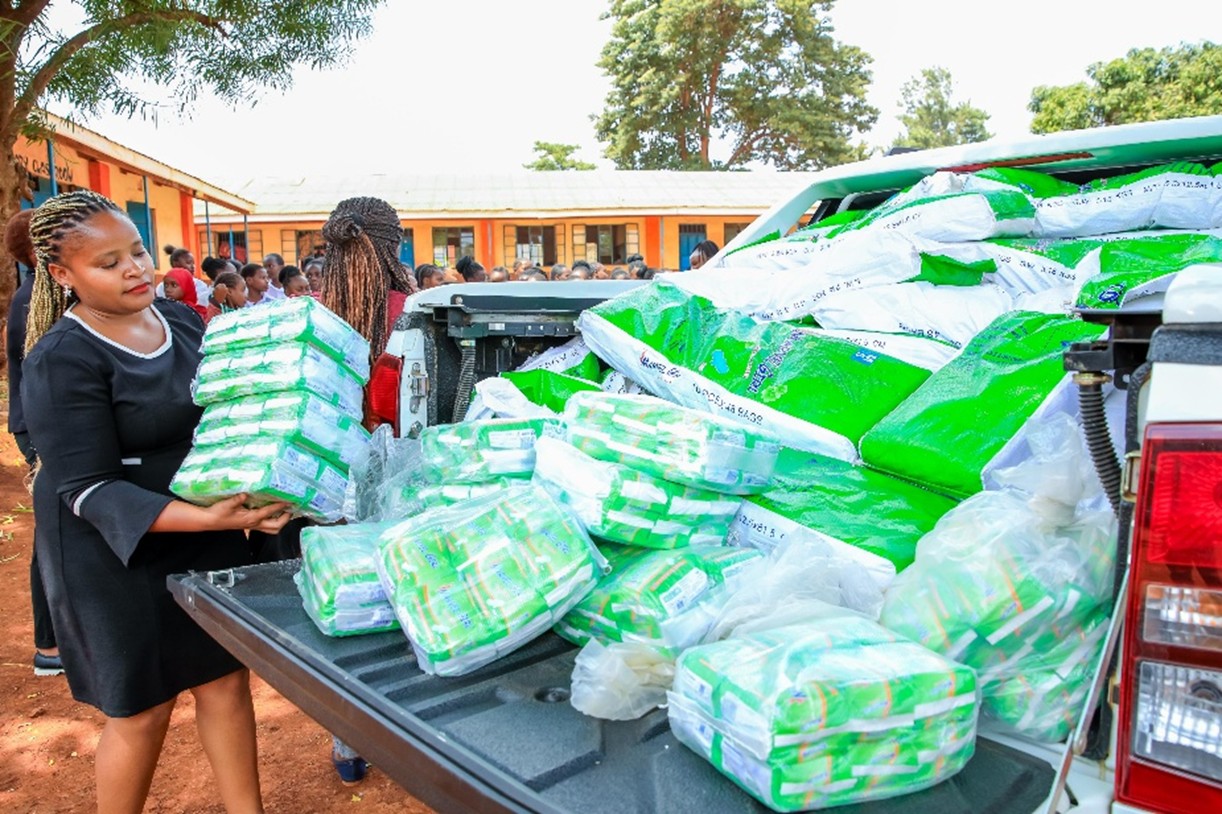 Director Gender, Doreen Nyaguthii Mwangi offloads Sanitary towels at one of the 20 beneficiary schools in Kirinyaga.